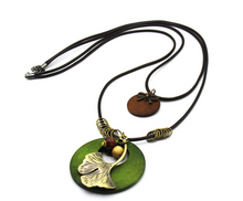 Load image into Gallery viewer, Vintage Ethnic Style Wooden Necklace Large Leaf Round Pendant Sweater Chain
